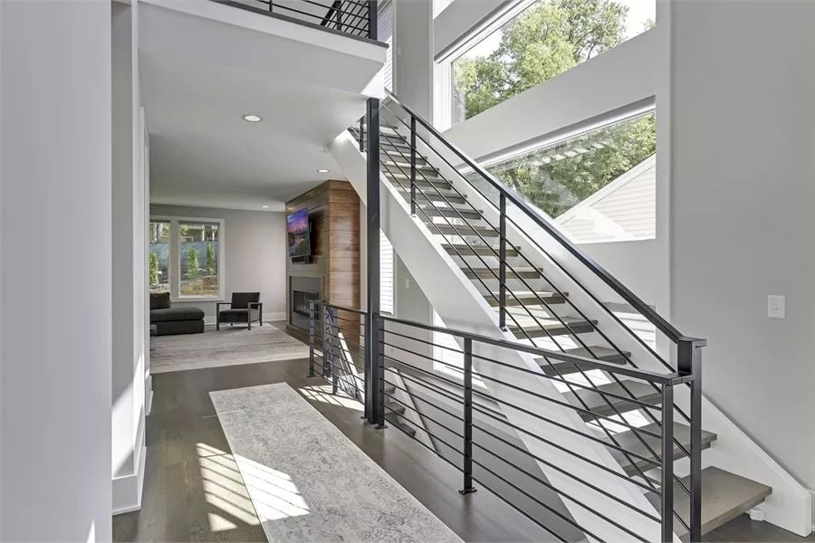 Floating Stairs, Steel Rails, and a Sightline That Runs Clear to the Fireplace