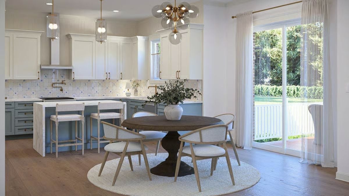 Sage Kitchen Cabinets and a Round Pedestal Table Make a Surprisingly Good Team
