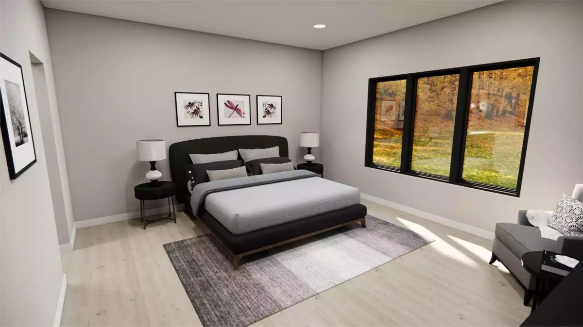 Black Bed Frame, Three Framed Prints, and a View That Does the Heavy Lifting