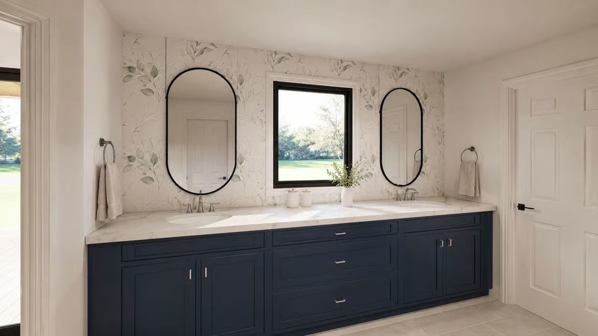 Navy Vanity Cabinets and Oval Mirrors Give This Bathroom a Strong Point of View