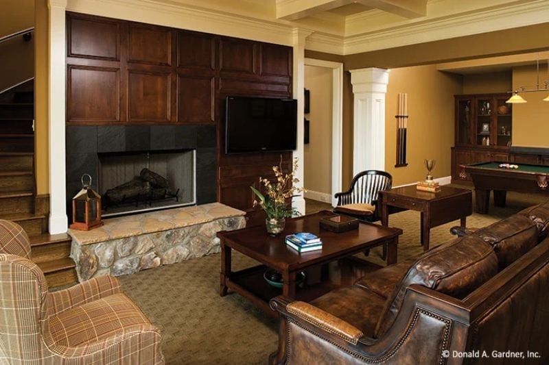 Leather, Stone, and Wood Paneling Pull the Weight in This Lower-Level Retreat