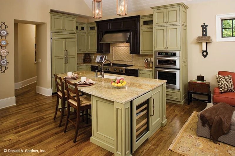Sage Cabinets and a Wine Fridge Built Into the Island Say "We Planned Ahead"