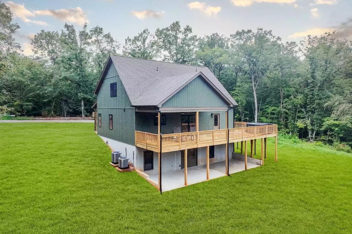Green Board-and-Batten Exterior with a Raised Deck Built for Two Generations