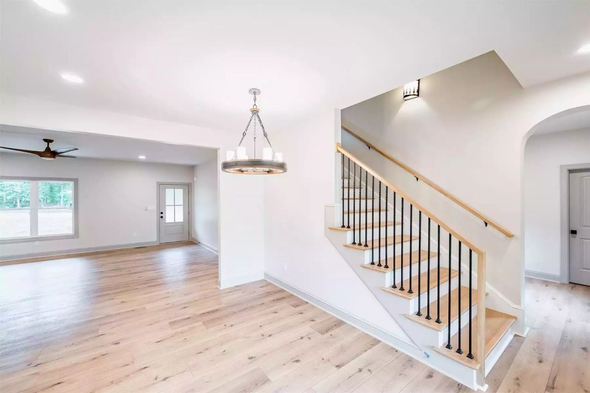Light Wood Treads and Iron Balusters That Know Exactly What They're Doing