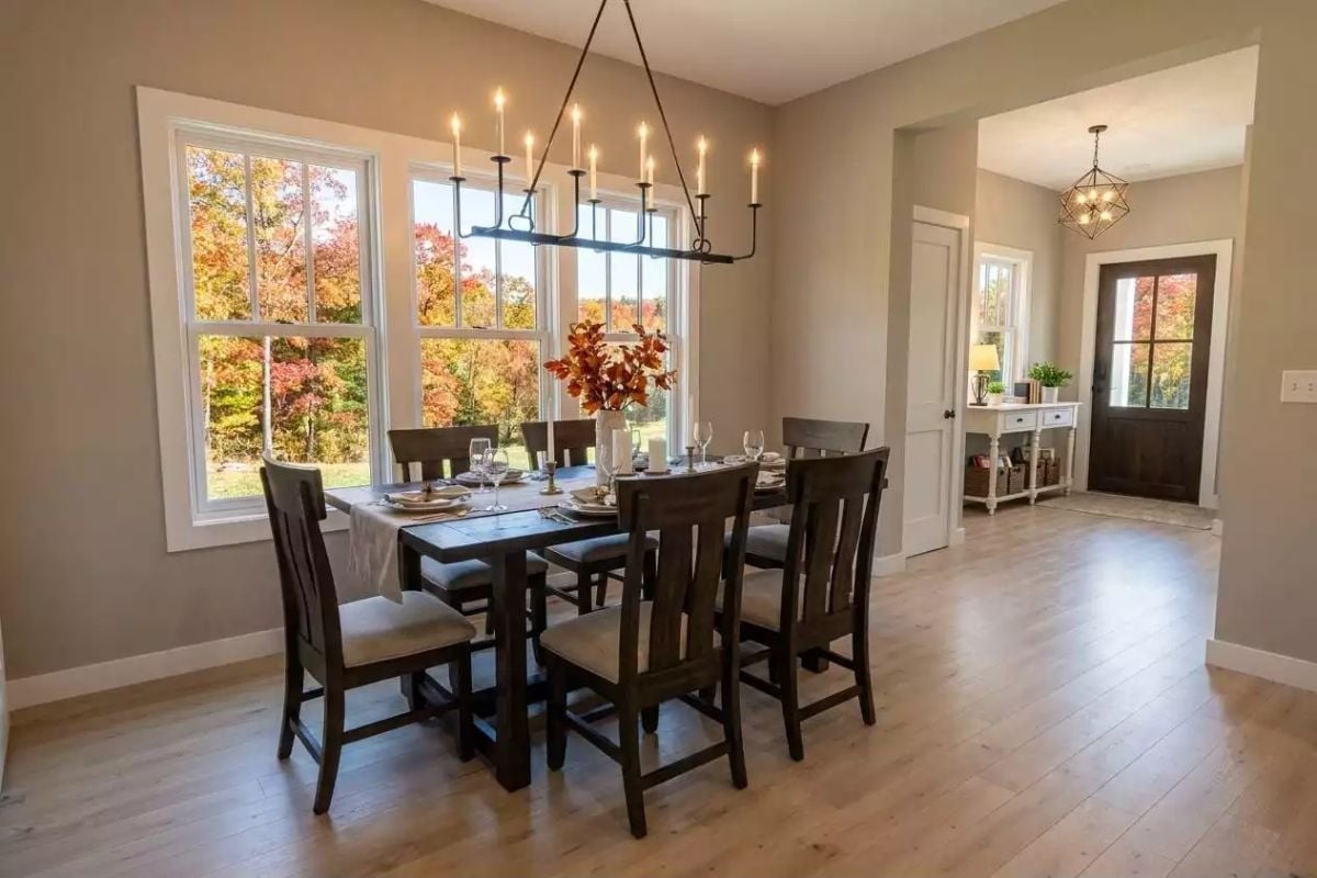 Candle-Style Chandelier Earns Its Keep Over a Dark Wood Dining Set