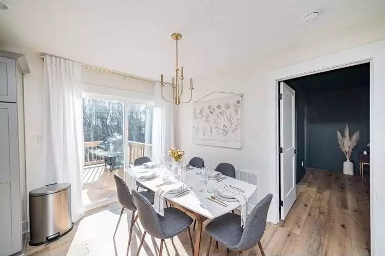Gold Chandelier, Linen Curtains, and a Dining Table Set Like Someone's Actually Coming to Dinner