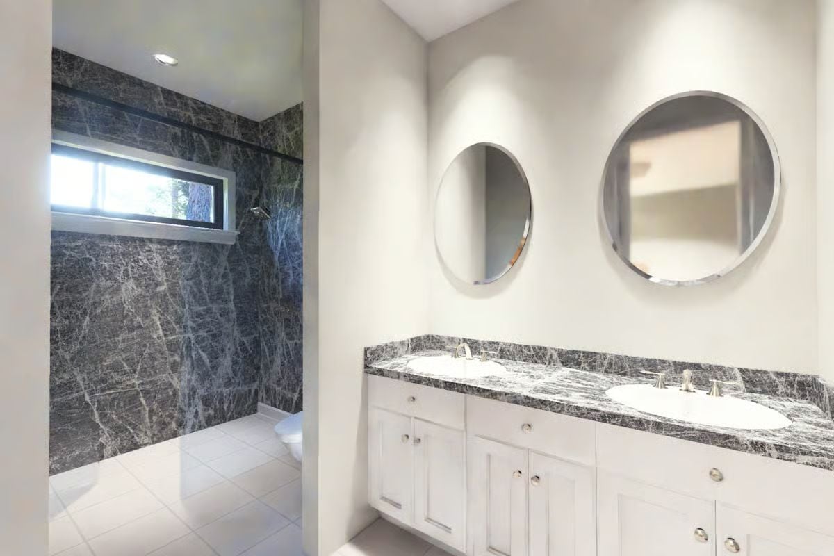 Dark Granite and Round Mirrors Earning Their Keep Above a Double Vanity