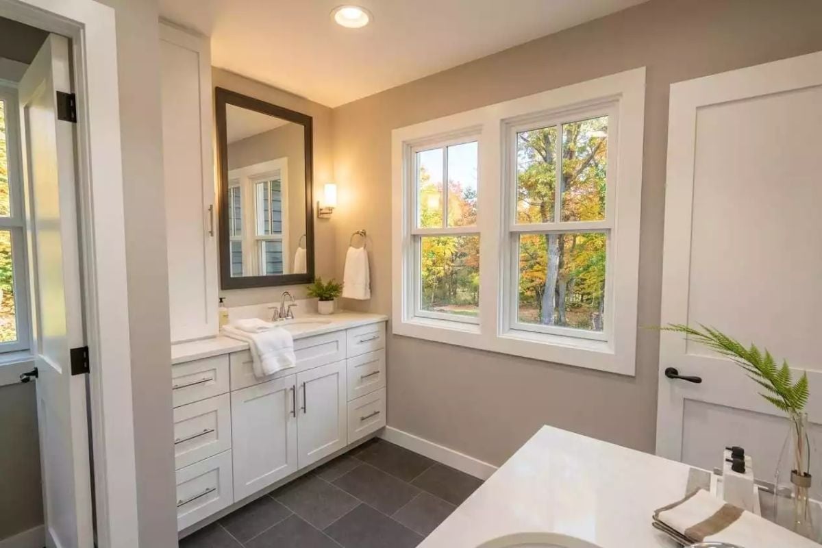 White Vanity Cabinetry With Fall Color Framed Right Outside the Window