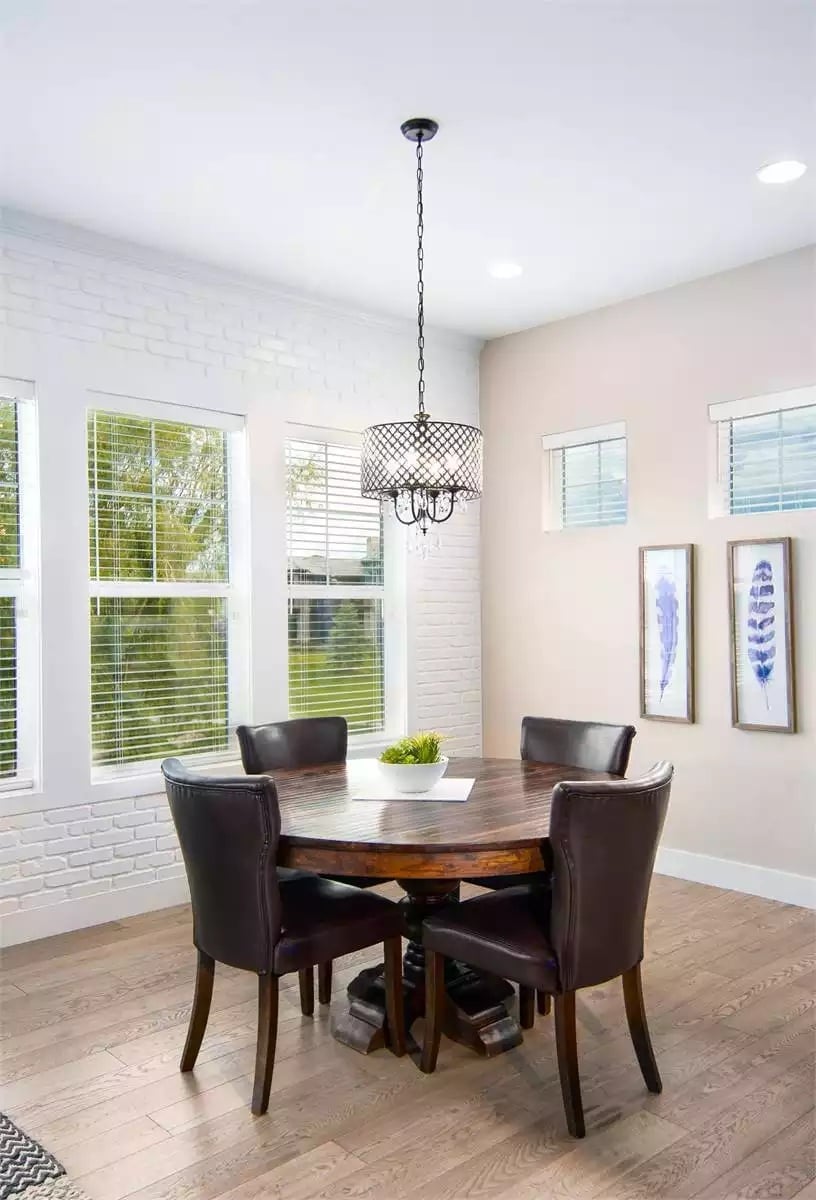 Drum Chandelier Over a Pedestal Table That Doesn't Fight for Attention