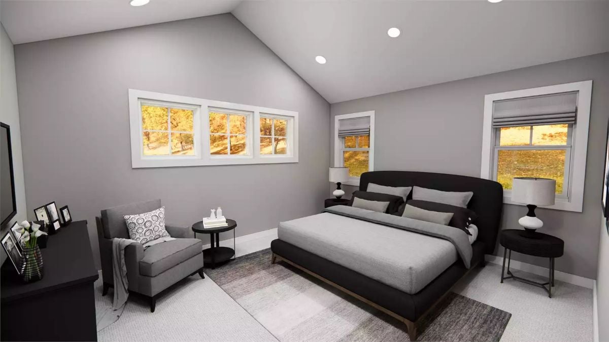 Vaulted Ceiling and a Dark Bed Frame That Anchor Without Overwhelming