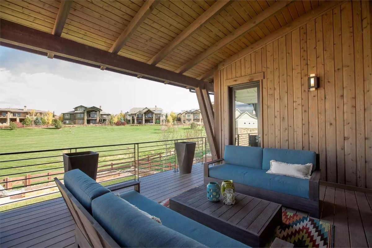 Covered Deck With Blue Cushions Earns Every Square Foot of Outdoor Real Estate