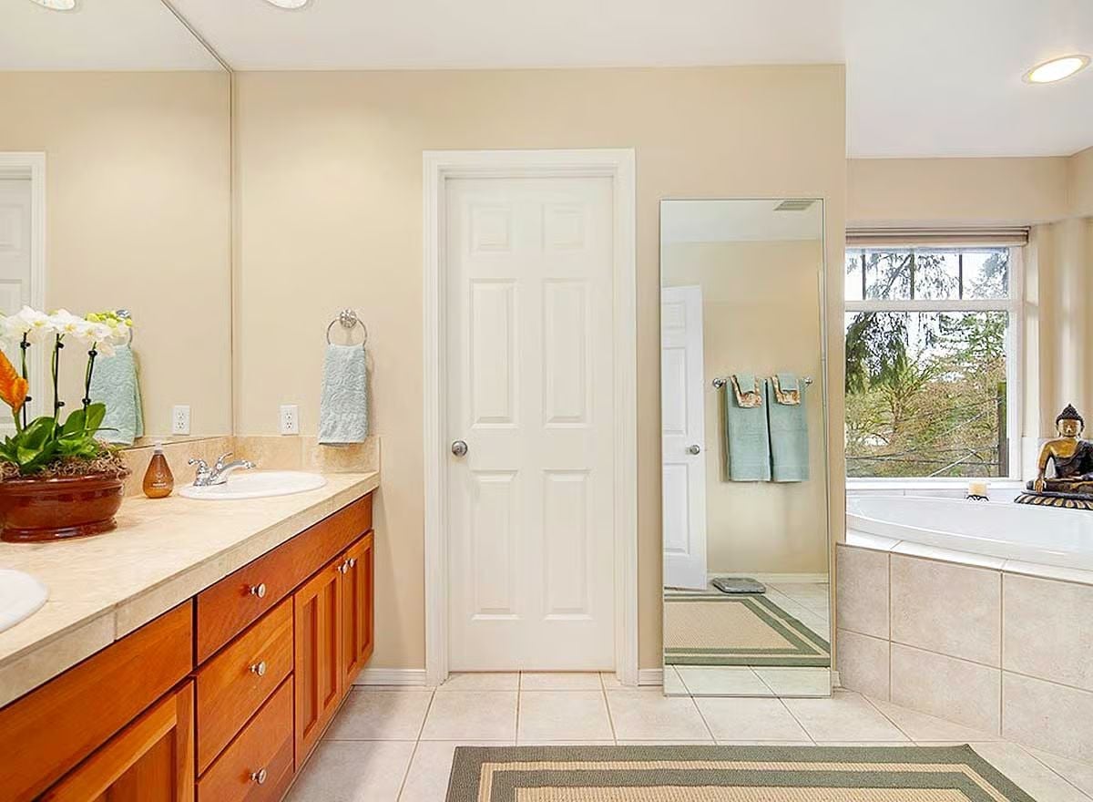 Buddha Statue by the Tub Makes a Design Point Without Trying Too Hard
