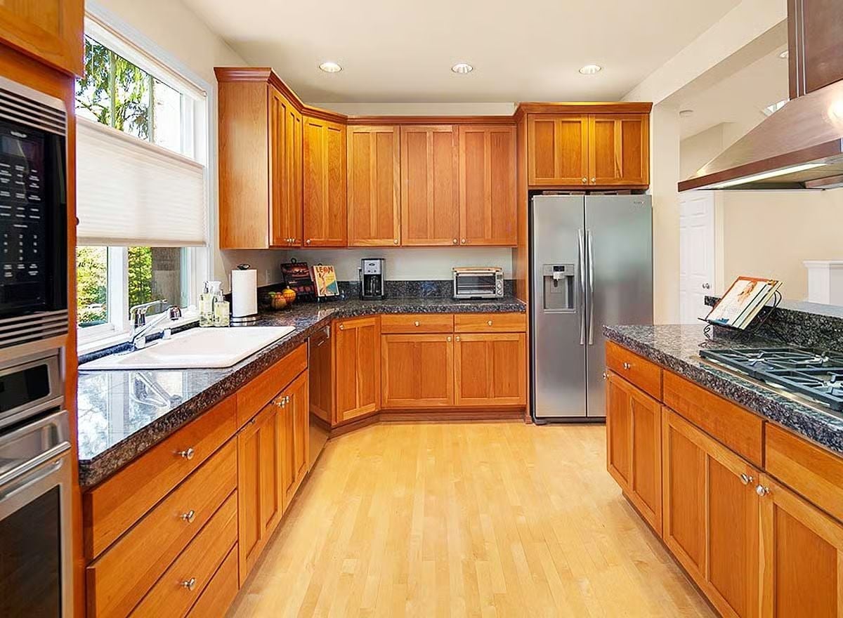 Honey-Toned Shaker Cabinets Pull Off What White Kitchens Can't