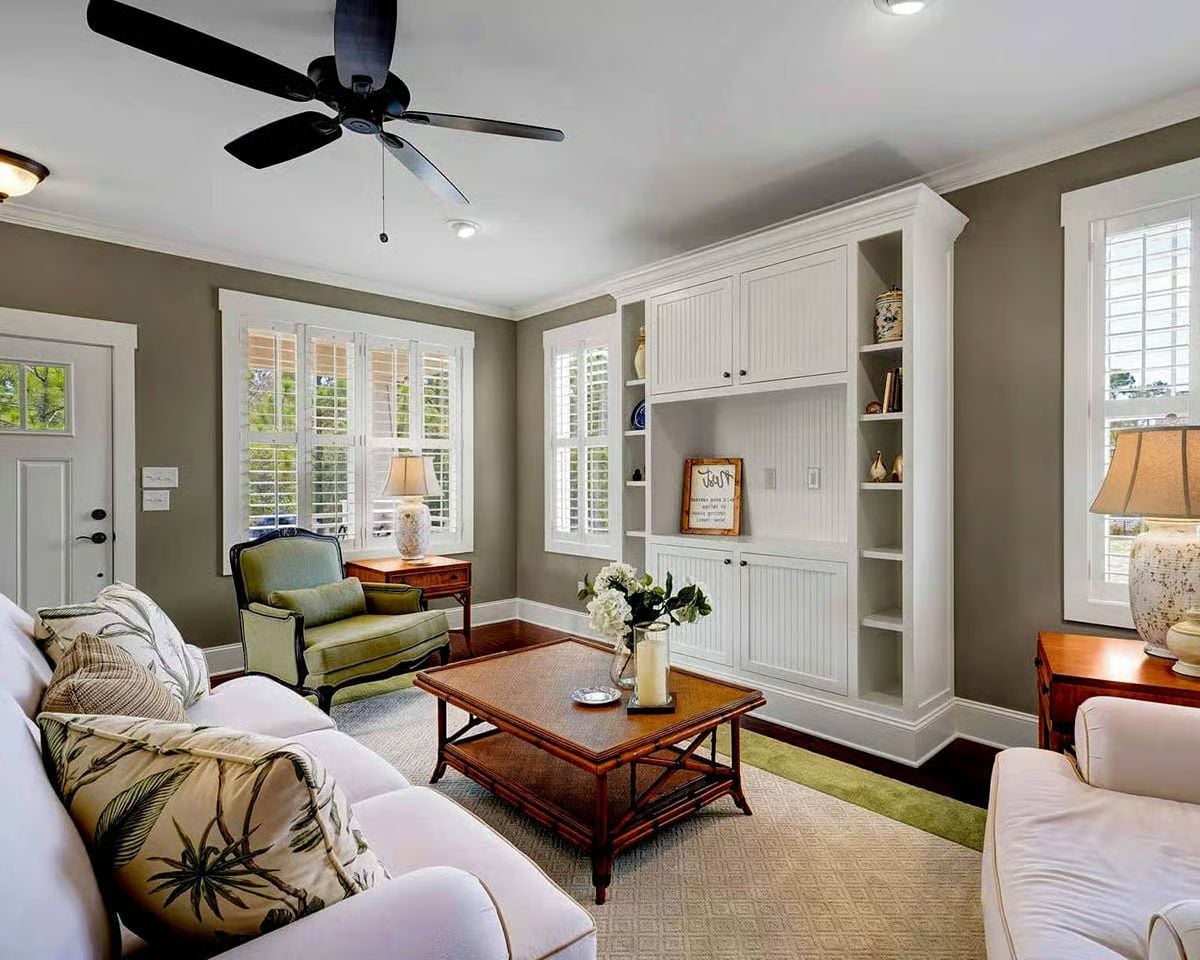Built-In Shelving and Plantation Shutters Ground a Room That Earns Its Ease