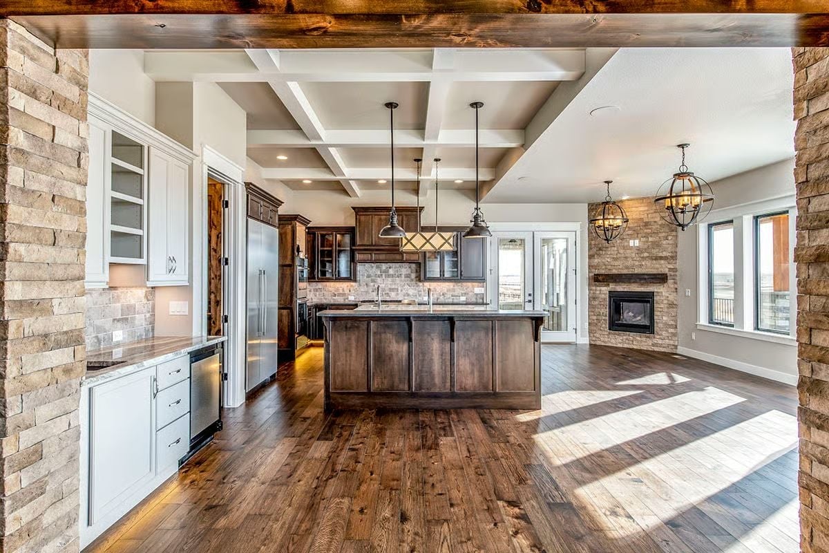 Coffered Ceilings, Stone Columns, and a Kitchen Island That Earns Its Square Footage