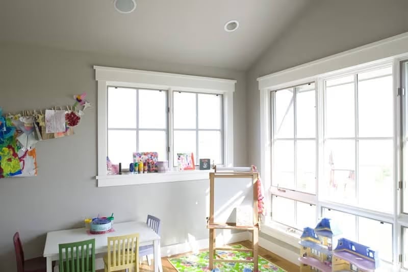 Bright Playroom Corner Keeps Art Supplies, Easels, and Dollhouses All in One Place
