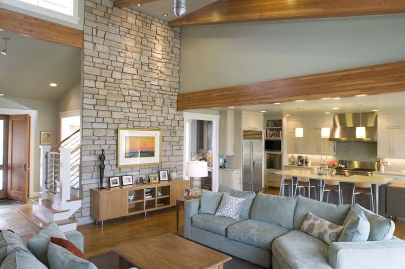 Soaring Stone Fireplace Wall Anchors an Open-Concept Living Space