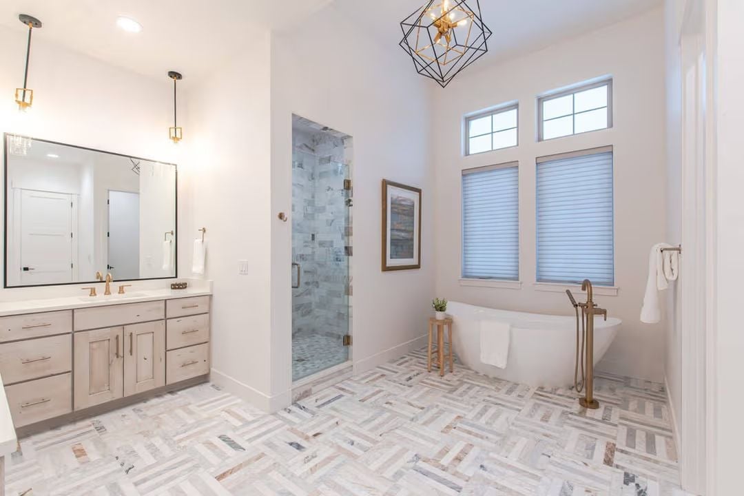 Freestanding Tub, Geometric Chandelier, and Herringbone Marble That Earns Every Glance
