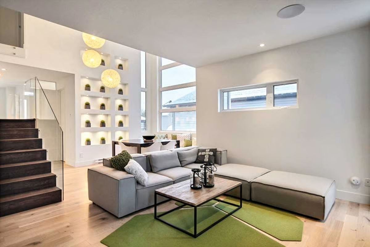 Globe Pendants and Built-In Niches Pull Double Duty in This Double-Height Living Room