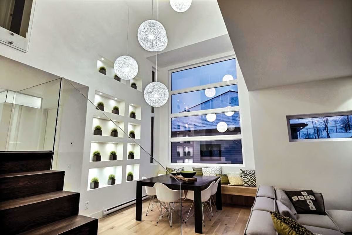 Globe Pendants Cascading at Double Height Do Something Rooms Rarely Pull Off