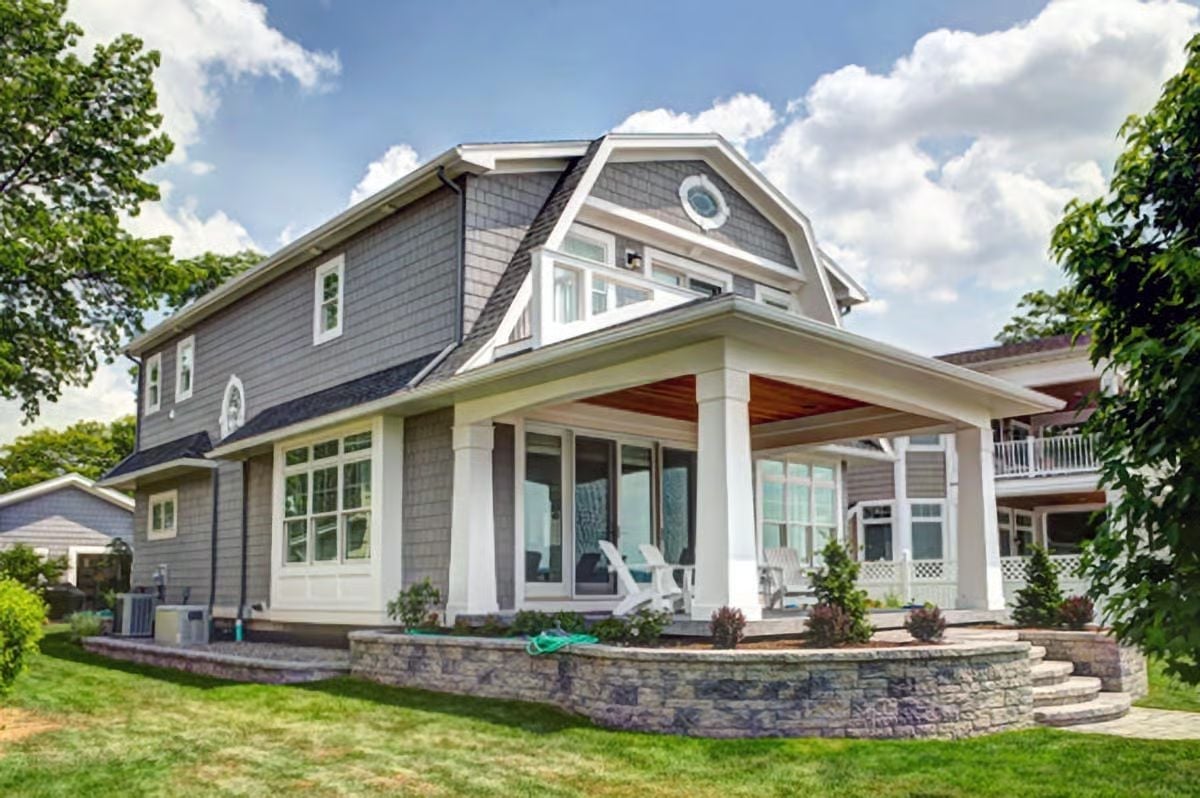 Gray Shingle Gambrel With a Covered Porch Built for Real Outdoor Living
