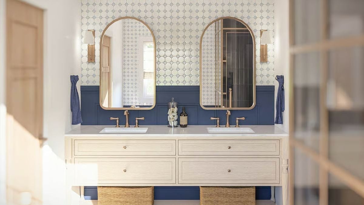 Gold-Framed Arched Mirrors and Navy Wainscoting Give This Bathroom Its Character