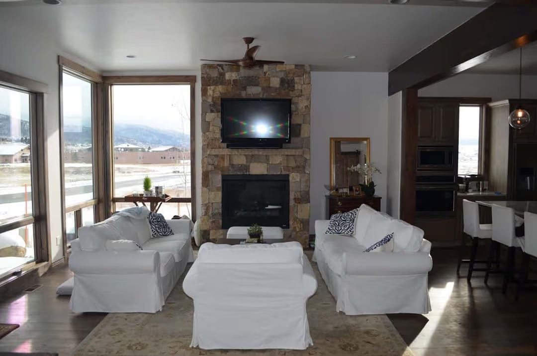Stone and White in a Mountain Living Room That Earns Its Keep