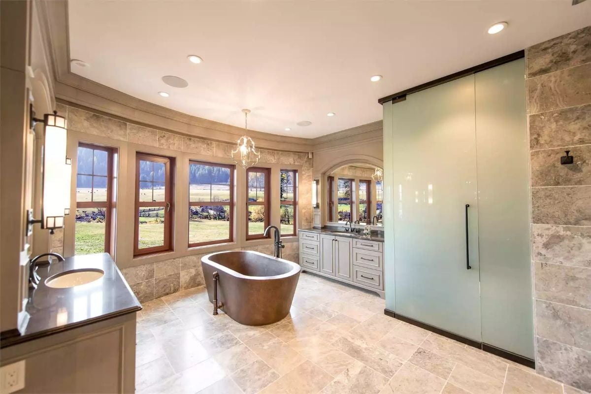 Copper Soaking Tub Positioned to Catch the Pastoral View Through Five Windows