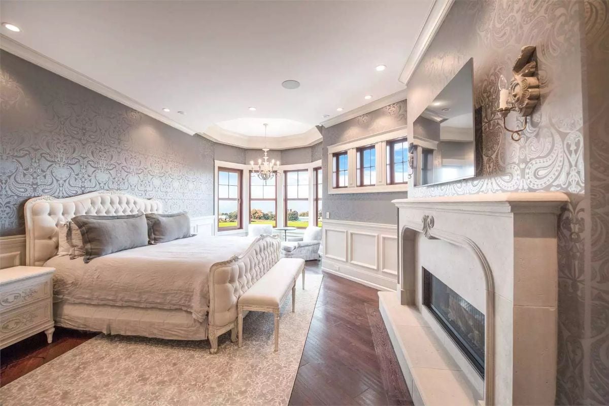 Silver Damask Wallpaper and a Stone Fireplace Mantel Pull the Master Suite Together