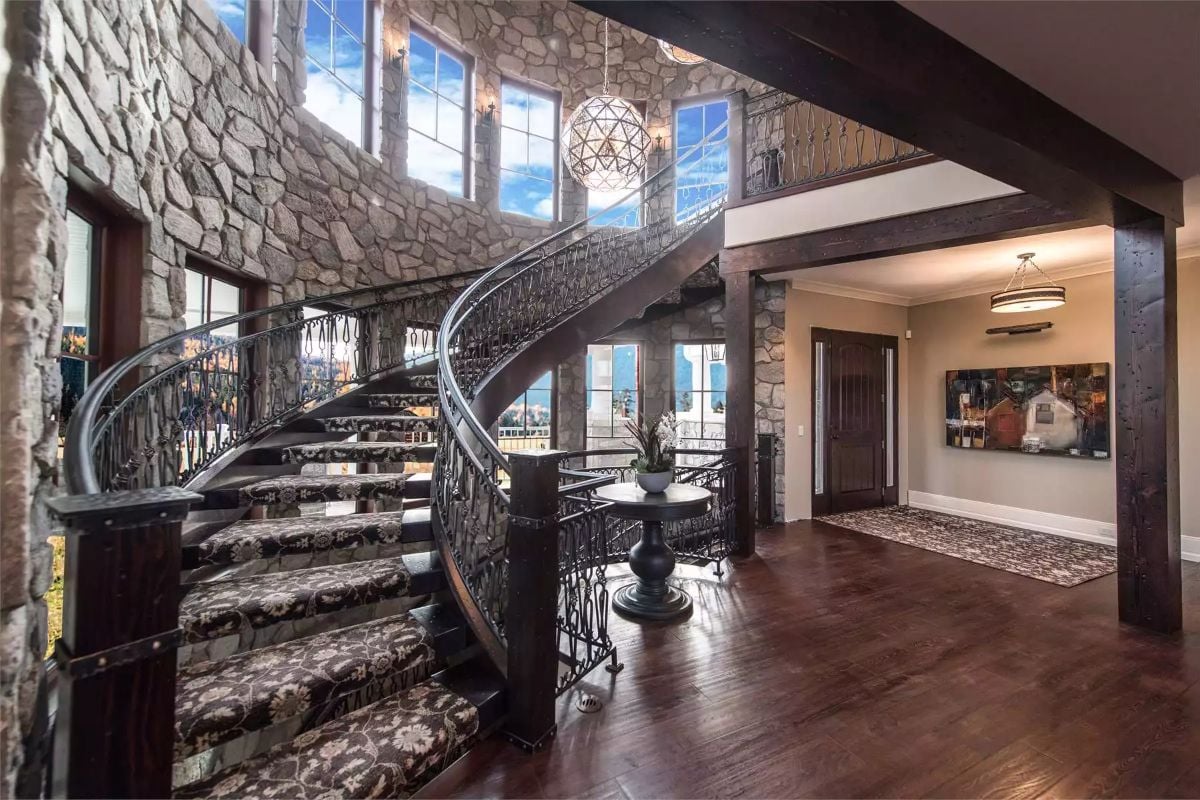 Wrought Iron Spiral Staircase Commands the Entire Entry Hall