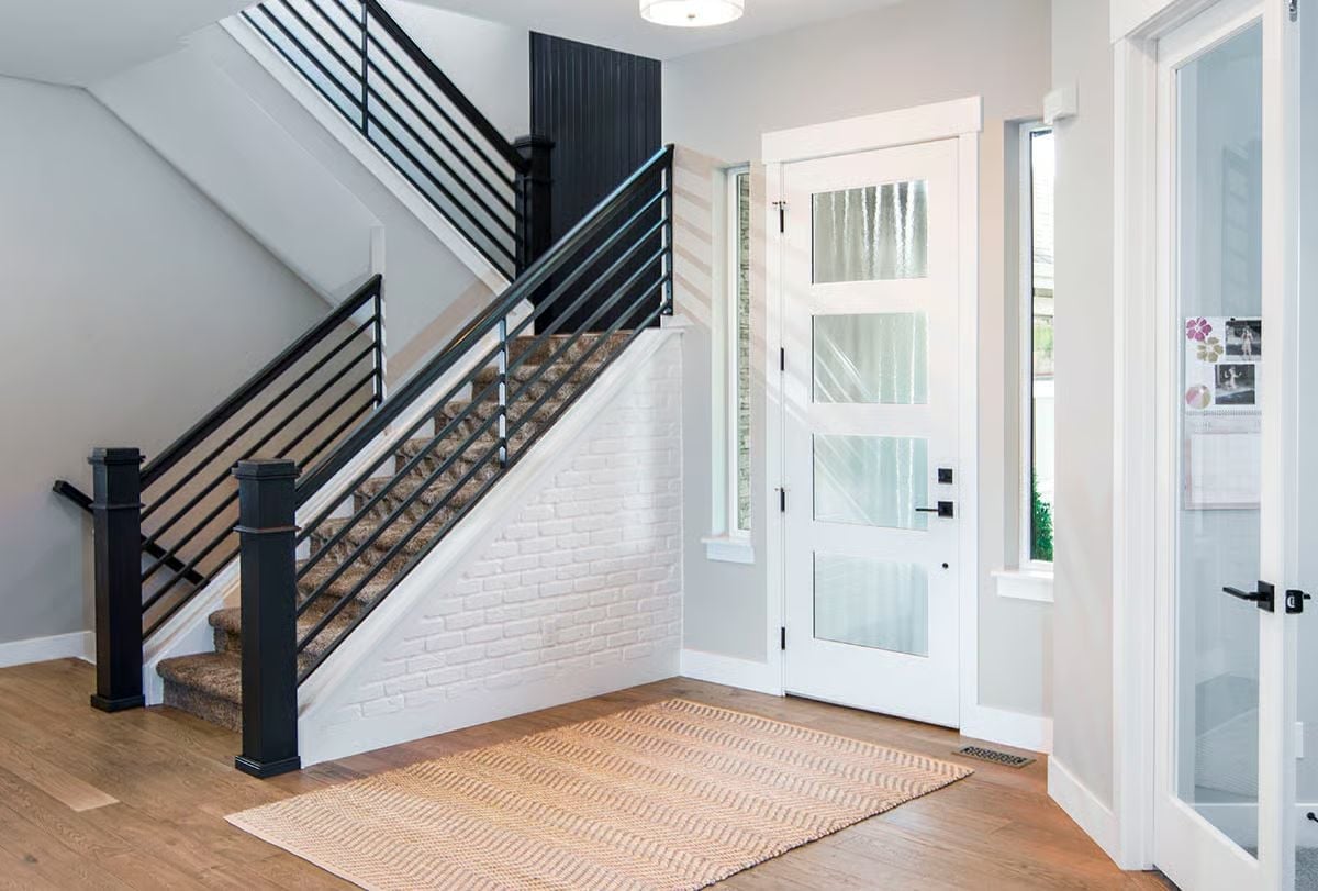 Black Horizontal Railings and Painted Brick Pull This Entry Together