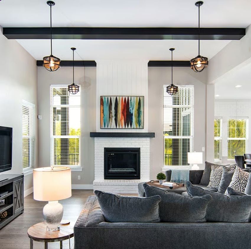 Shiplap, Painted Brick, and Black Beams Do a Lot of Work in One Room