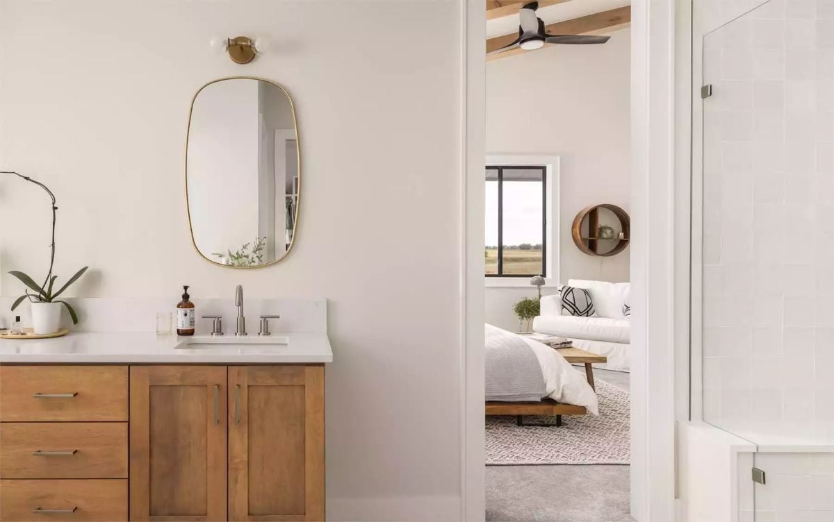 Gold-Framed Mirror, Wood Vanity, and a Bedroom That Waits Just Beyond the Door