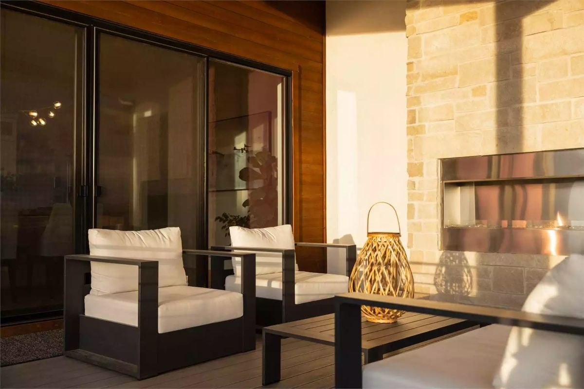 Outdoor Fireplace Built Into Limestone, Two Chairs Ready for Anyone Who Sits Down