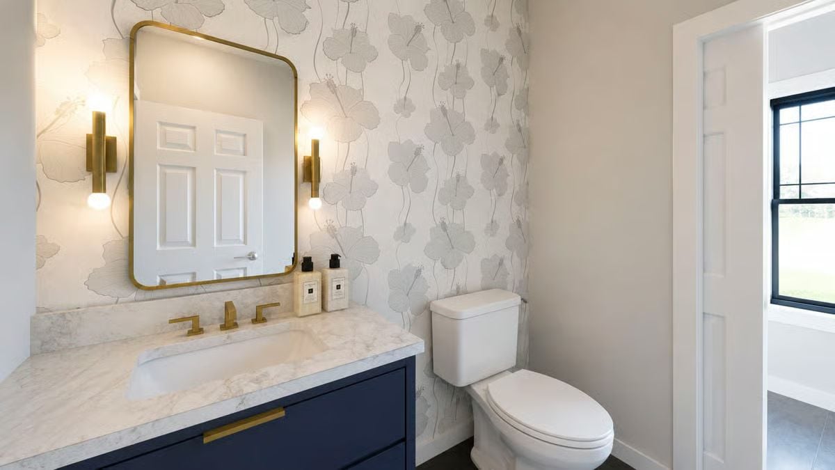 Brass Fixtures, Navy Vanity, and Wallpaper That Actually Earns Wall Space