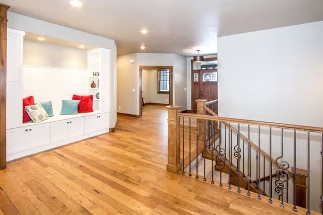 Built-In Bench Nook with Storage Cabinets Anchors the Upper Hallway