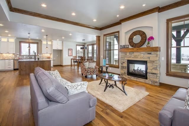 Stone Fireplace and Exposed Ceiling Beams Ground an Open-Concept Great Room