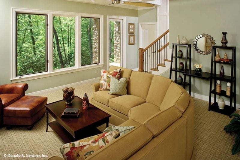 Curved Sectional and Wooded Views Make This Family Room Hard to Leave