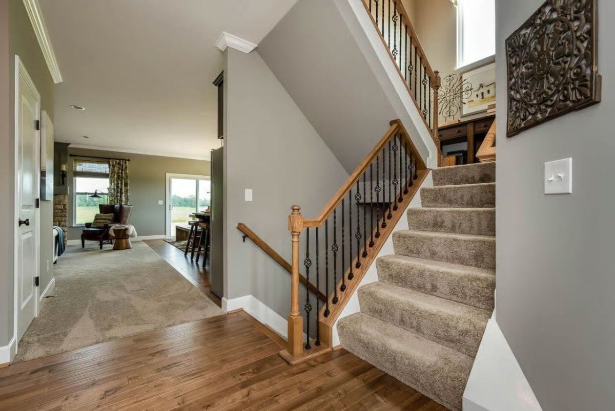 Oak Handrail, Iron Balusters, and Carpet Treads That Hold Up to Real Family Traffic