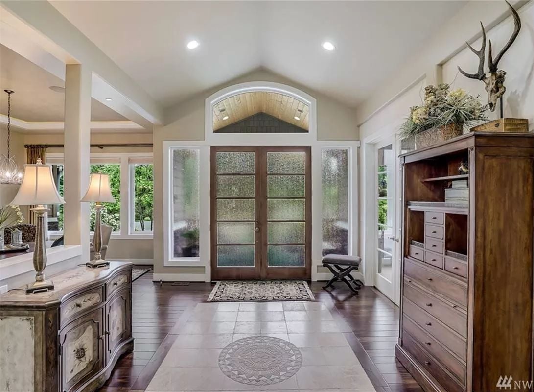 Arched Entry With Frosted French Doors and Antler Accents Sets the Tone