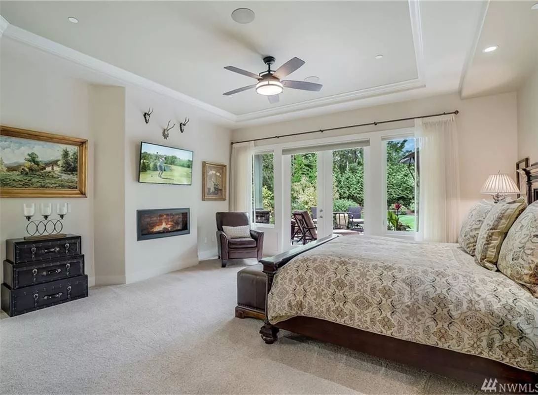 Master Suite Where a Linear Fireplace and French Doors Compete for Your Attention