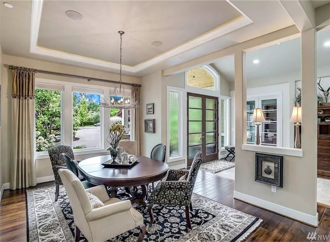 Round Dining Table Anchored by a Dark Floral Rug Does the Heavy Lifting Here