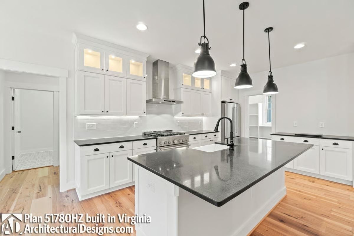 Dark Granite Island Anchors a Kitchen Built Around Natural Light