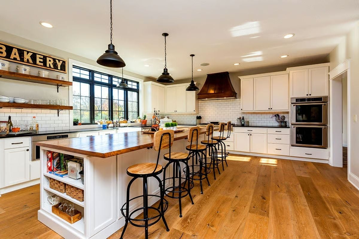 Butcher Block Island With Black Iron Barstools That Pull the Whole Room Together