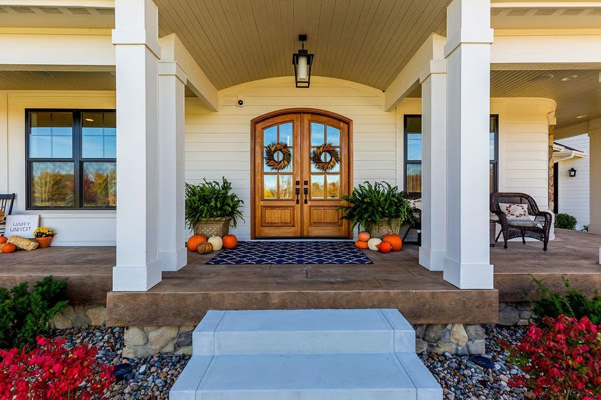 Wraparound Porch Entry Dressed for Fall With Double Arched Doors That Mean Business