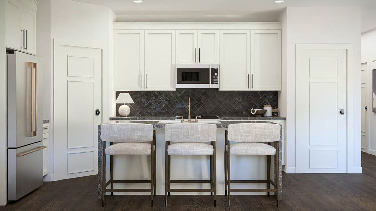 Dark Backsplash Tiles and Marble Counters Do the Heavy Lifting Here