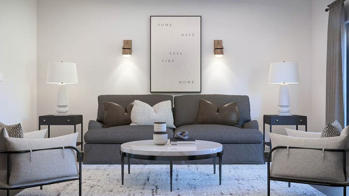 Warm Sconces and a Marble Table Keep This Gray Living Room from Feeling Cold