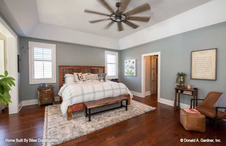 Carved Headboard, Eight-Blade Fan, and a Bedroom That Knows What It Is