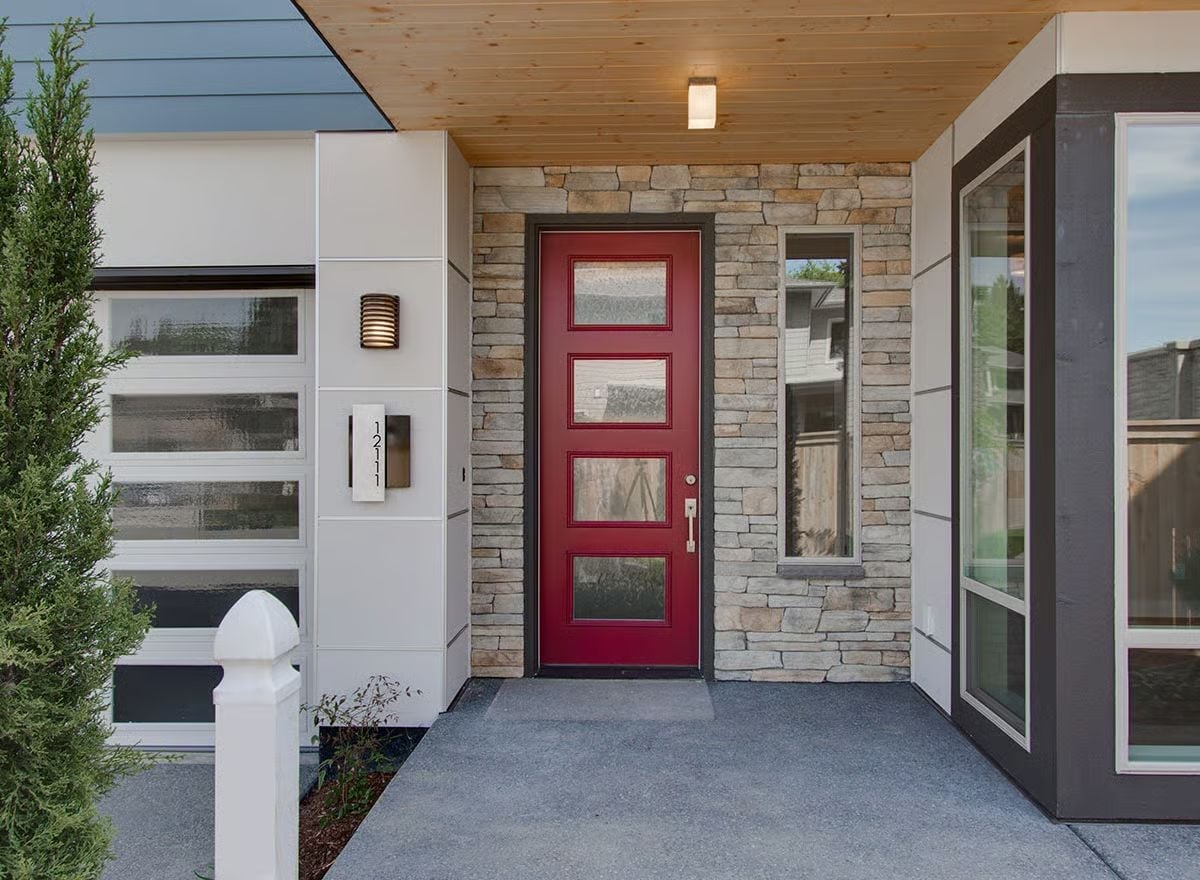 Red Door, Stone Surround, and a Covered Entry That Earns Its Keep