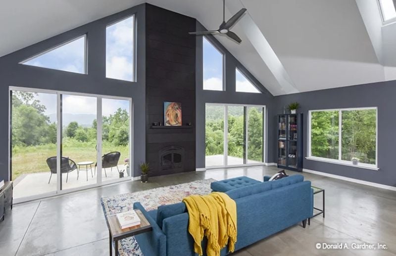 Vaulted Ceilings and a Dark Fireplace Wall That Pull the Outdoors In